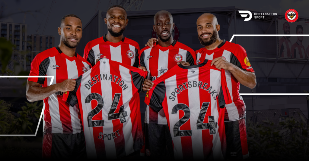 four Brentford FC players holding a Brentford shirt with 'Destination Sport 34' printed on it