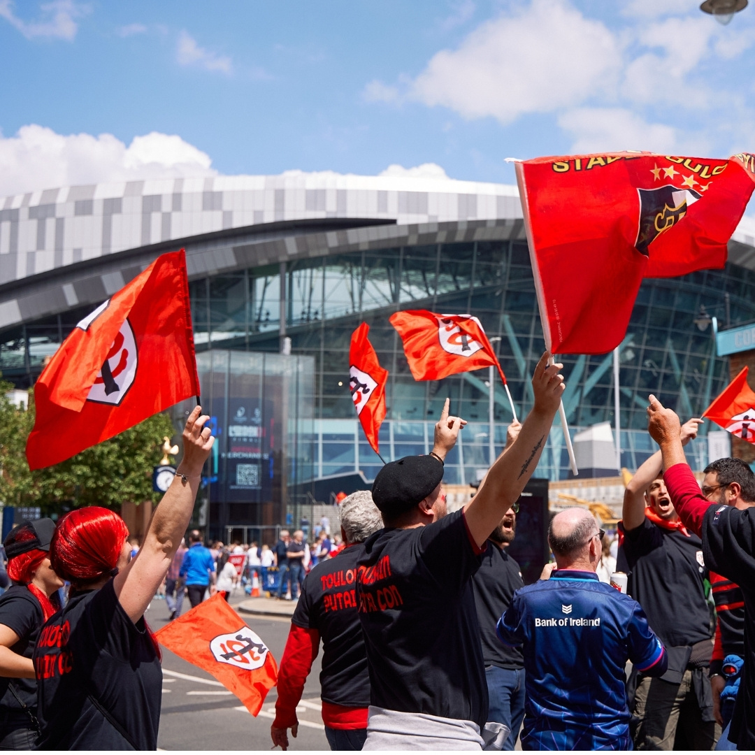 fans waving flags ahead of the 2023 EPCR final at the Tottenham Hotspur Stadium