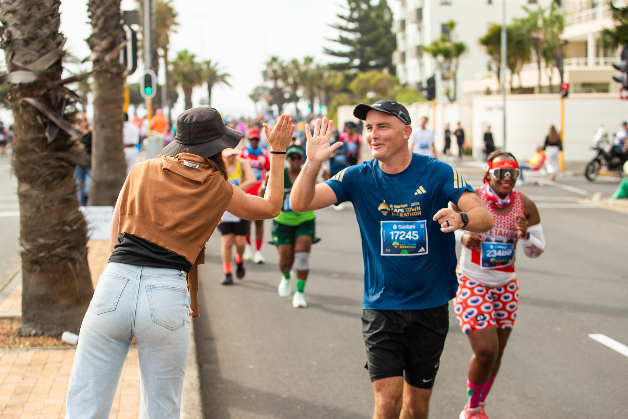 A runner high fives a supporter during the Cape Town Marathon